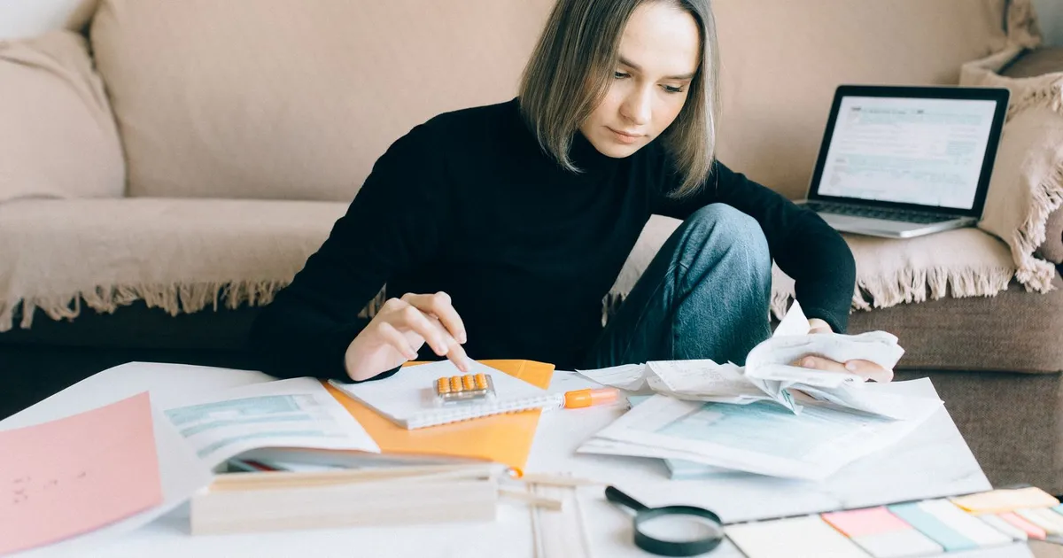 Calculator and monthly budget sheet on a kitchen table, used to size installment loans Saskatoon borrowers repay over 3 to 60 months